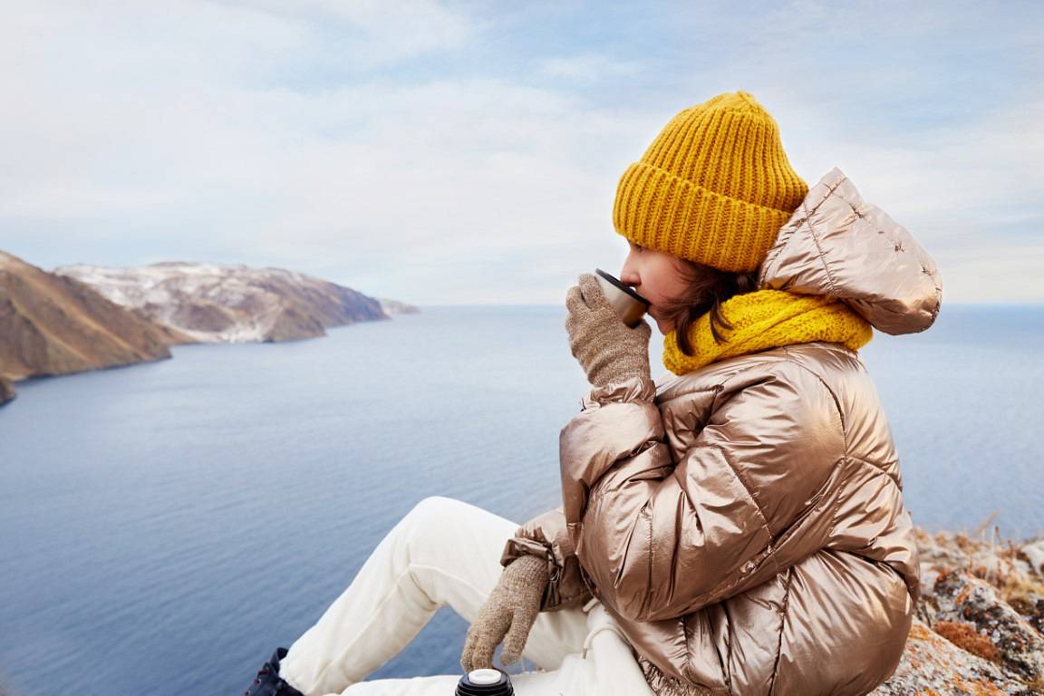 a-young-girl-traveler-drinks-hot-tea-from-a-thermo-2022-11-16-17-24-12-utc.jpg